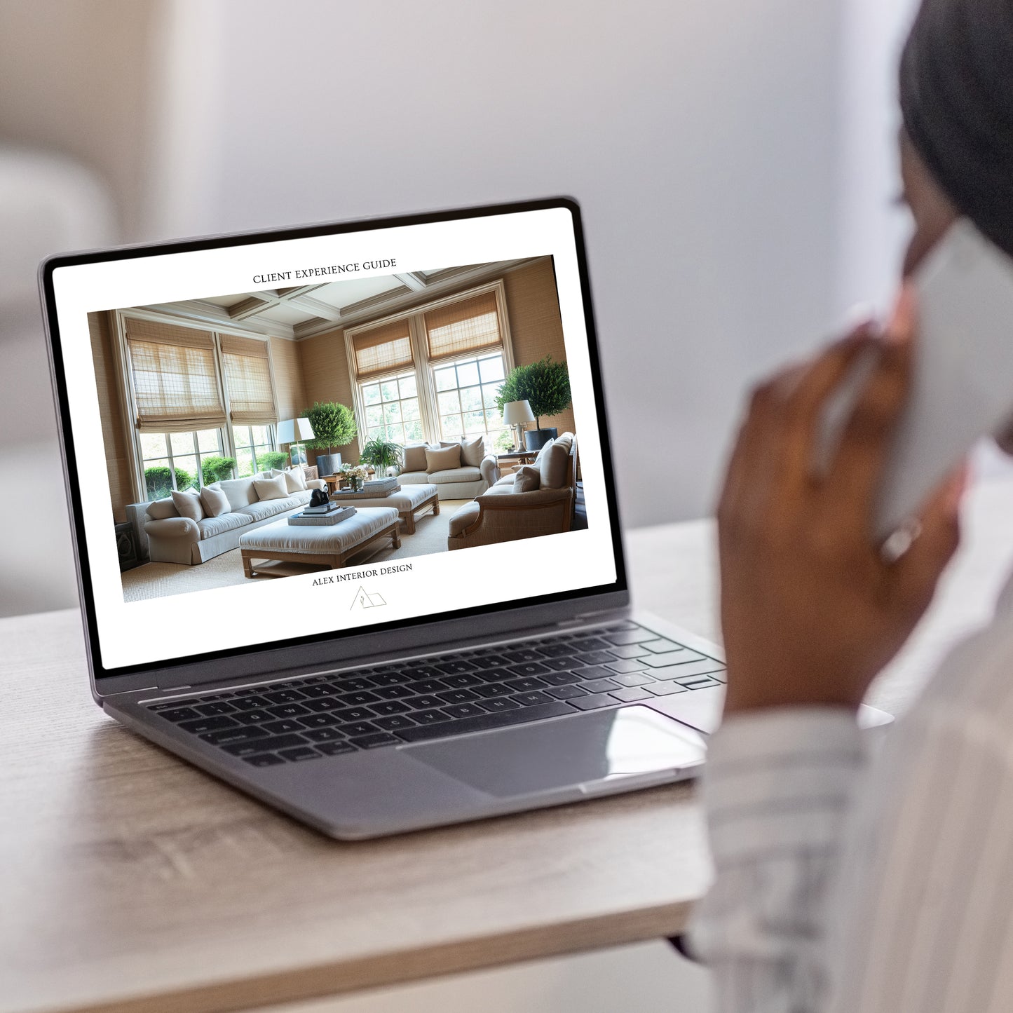 An interior designer working on a laptop with the LSI Workshop Client Experience Guide template. From the Alex Collection. 