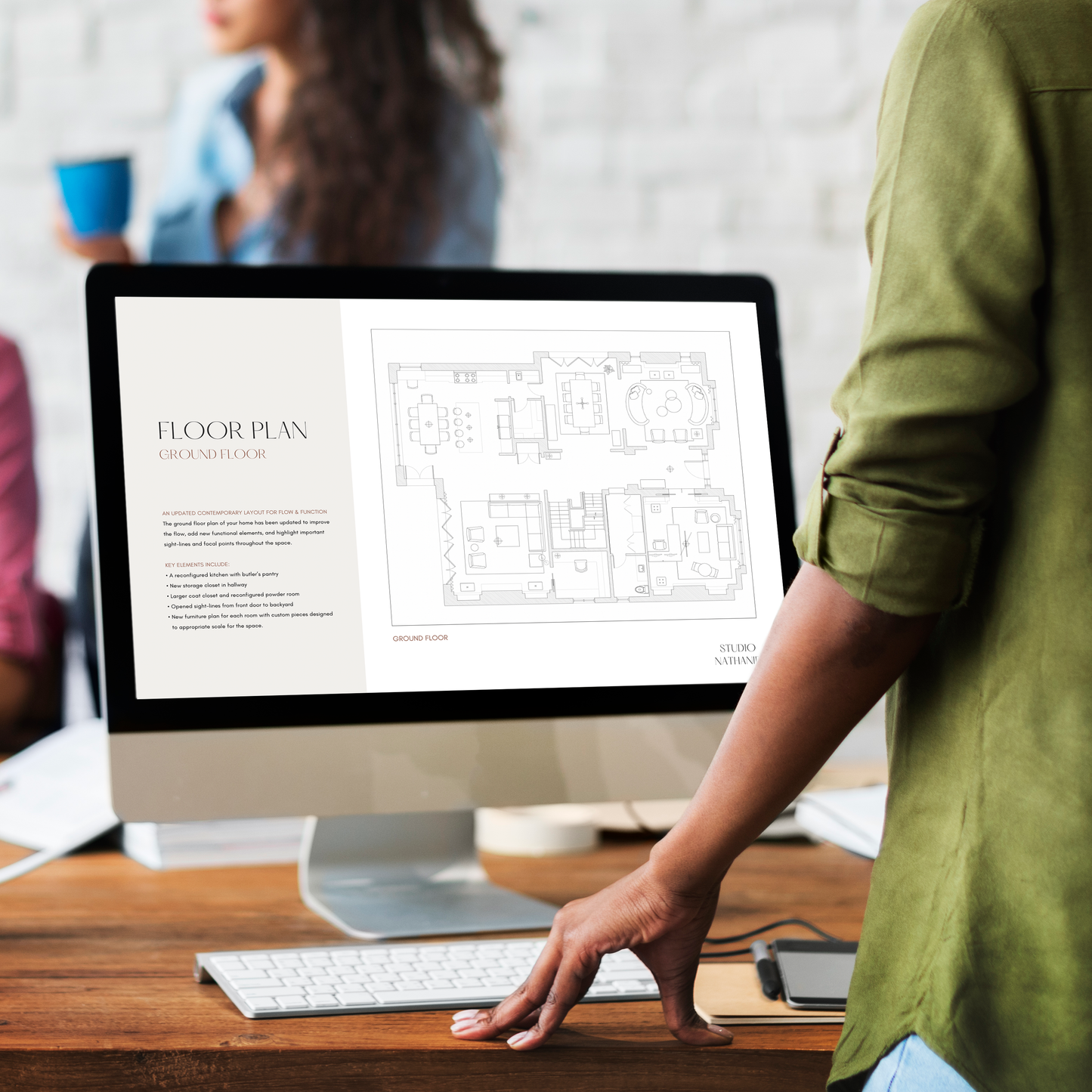 An interior designer reviewing a floor plan in the Design Presentation template from LSI Workshop, Nathaniel Collection.