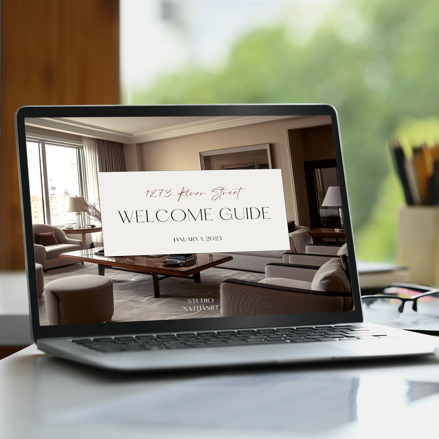 A laptop displaying the customizable New Client Welcome Guide for Interior Decorating Projects with placeholders for logo and imagery. From LSI Workshop, the Nathaniel Collection.